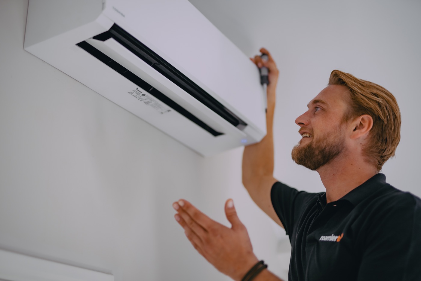 Technician servicing a heating and cooling system